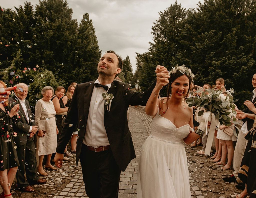 front-view-of-happy-newlywed-couple-walking-throug-min